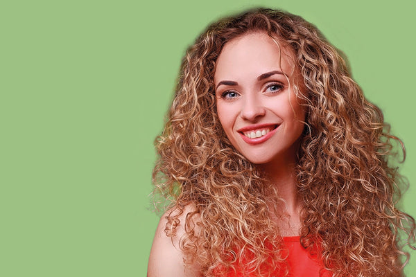 Woman with curly hair on a green background