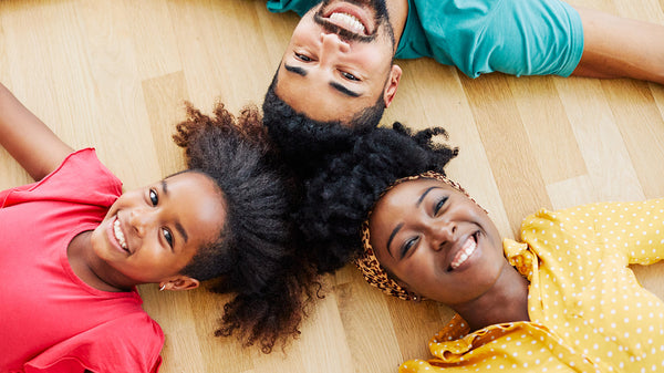 Three people with coily hair