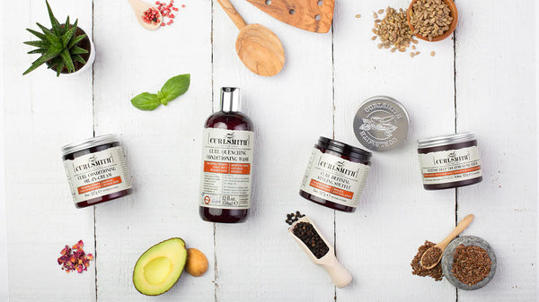 Curlsmith products and ingredients on a white background