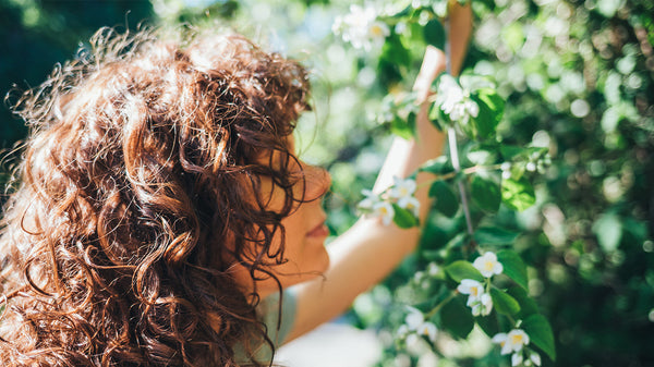 Woman with curly hair among plants