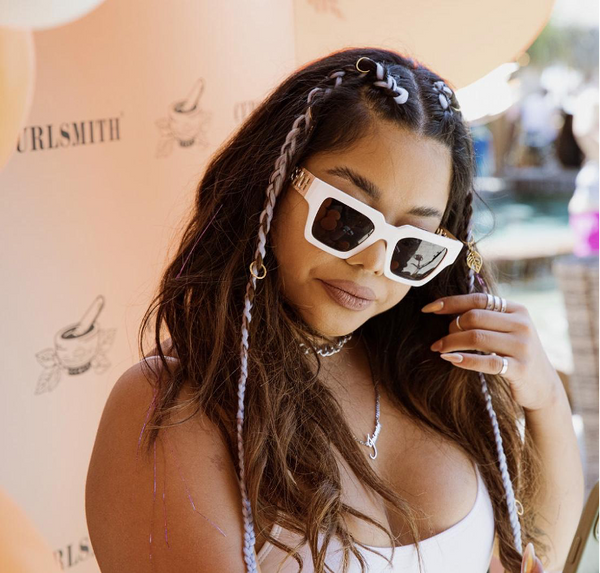 Woman with braids on a background with label Curlsmith