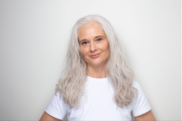 Woman with white hair on a grey background