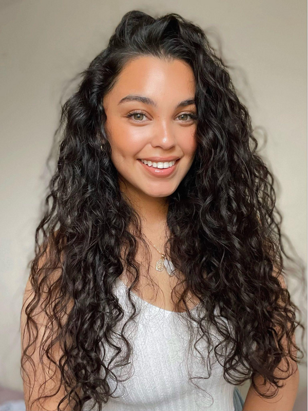 Woman with long curly hair on a grey background