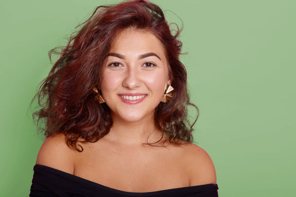 Woman with wavy hair on a green background