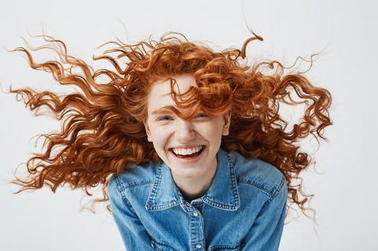 Smiling woman with flowing curly hair