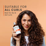 Woman holding a bottle of Curly Smith hair product with text about suitability for all curls on an orange background