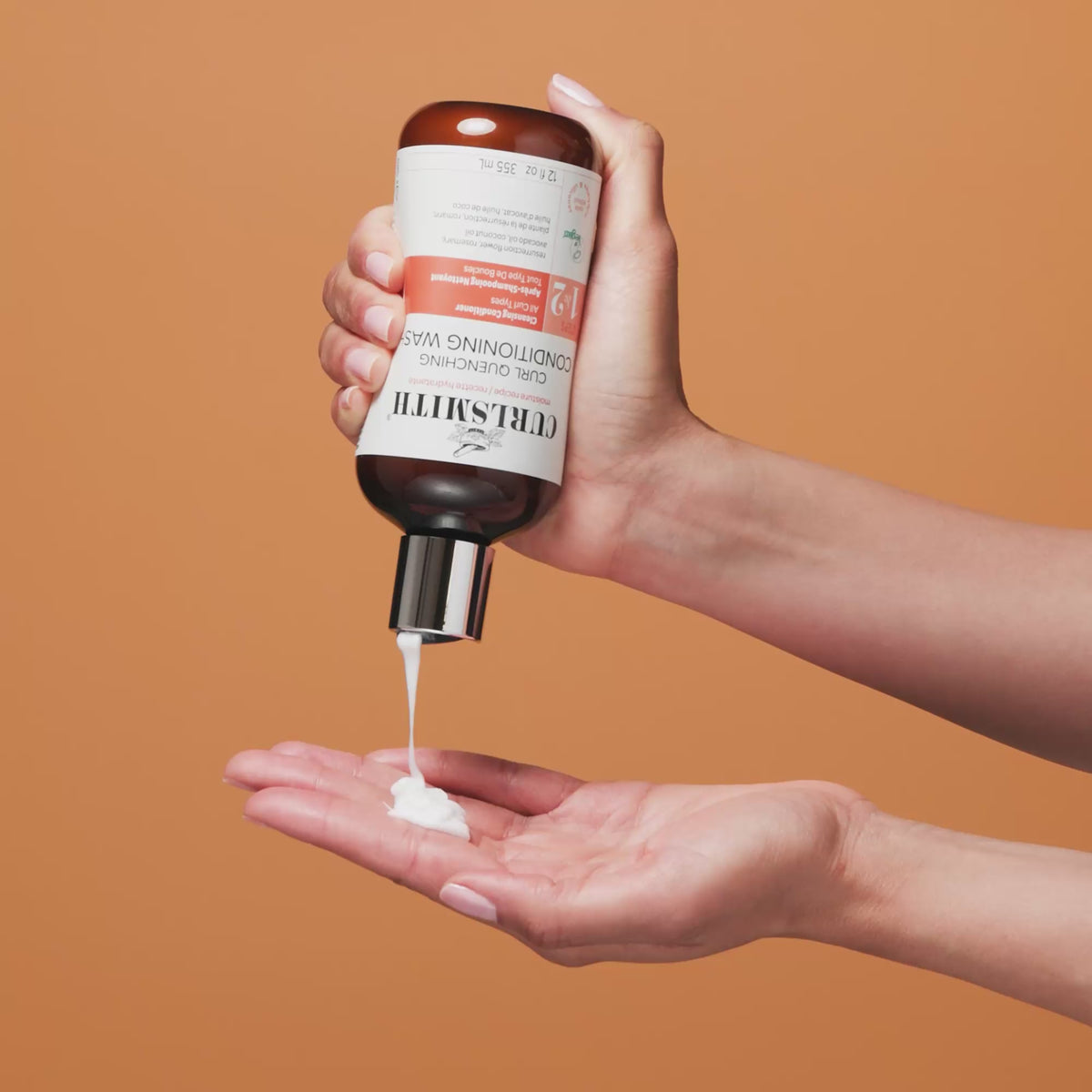 Hand holding Curl Quenching Conditioning Wash