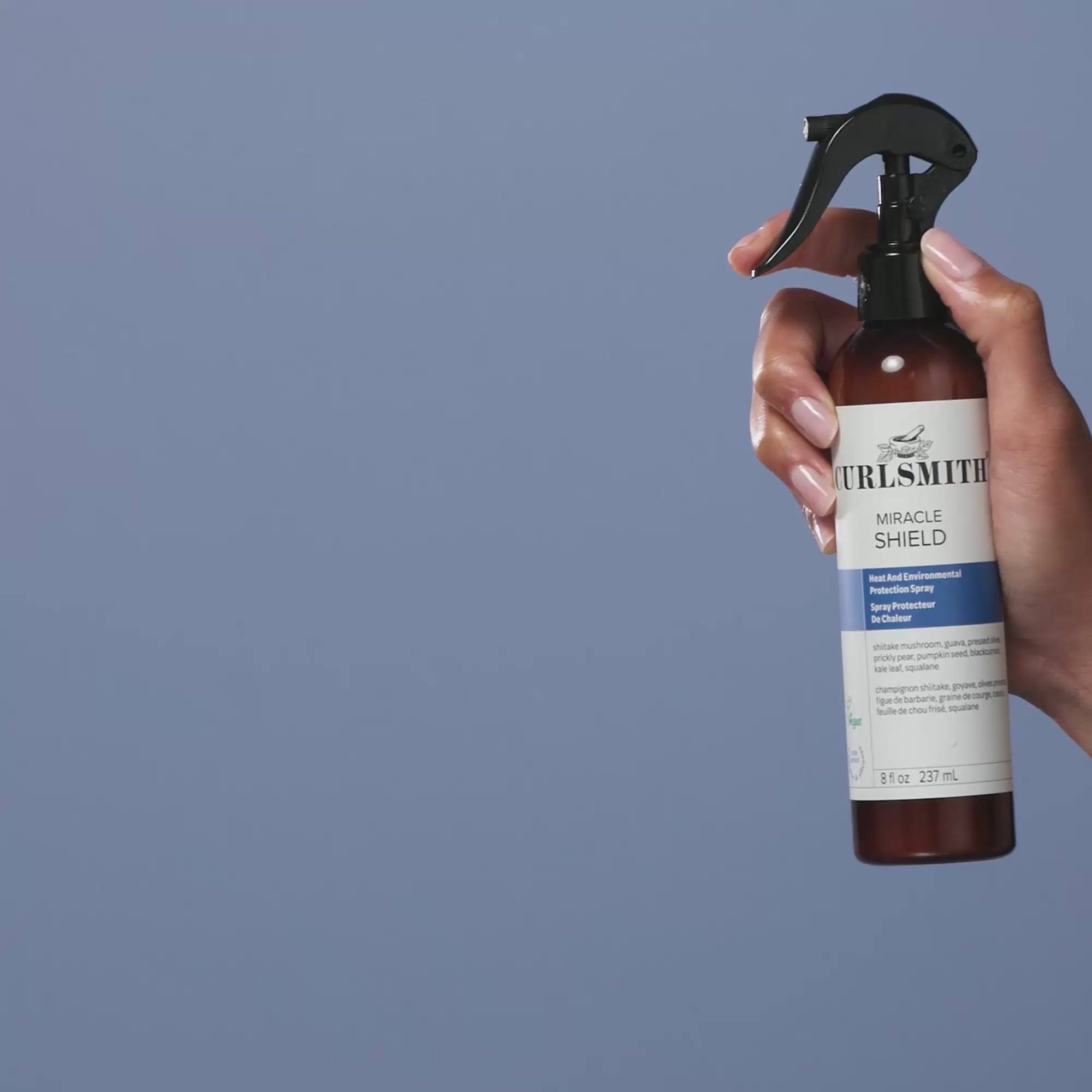 Hand holding Curlsmith Miracle Shield product