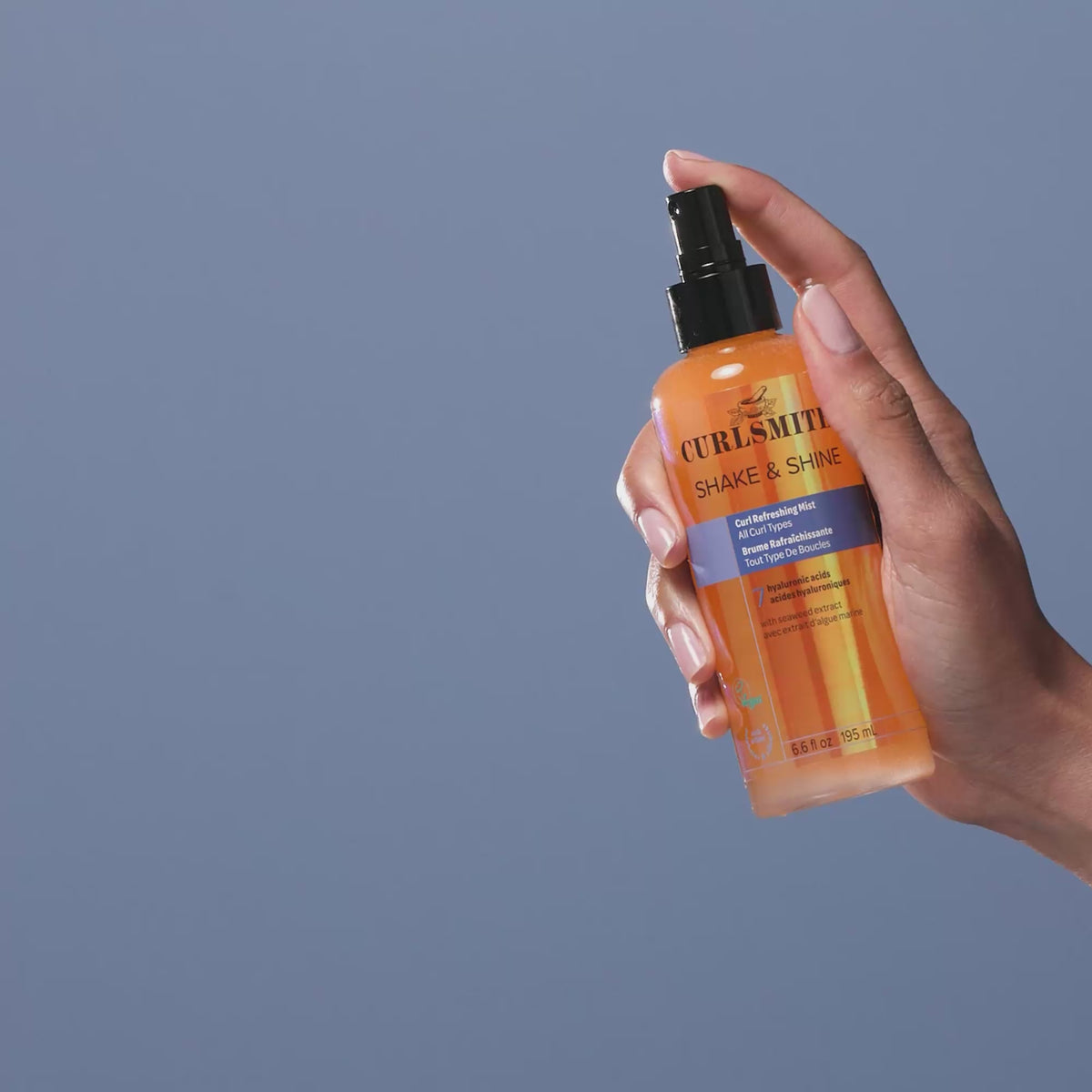 Person applying Curlmith Shake & Shine