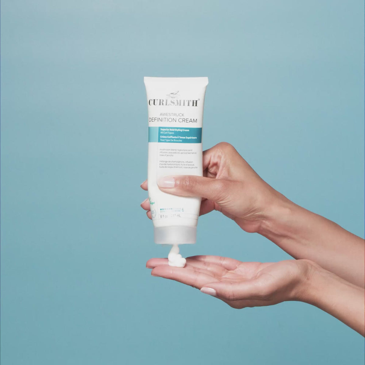 Hand holding Curlsmith Awestruck Definition Cream